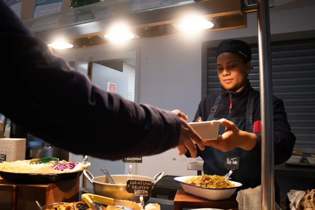 Chef serving & smiling